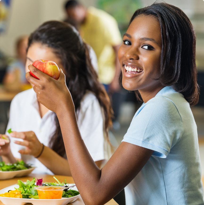 Student eating an apple for PrimeroEdge